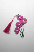 Floral pink bookmark with long green stems with tassel on a light gray background