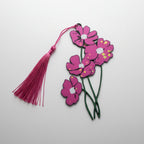 Floral pink bookmark with long green stems with tassel on a light gray background