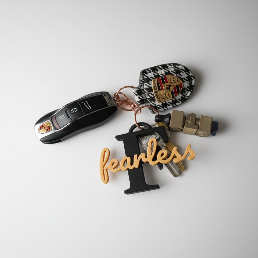 Custom name keychain in biodegradable PLA with personalized text, shown on keys
