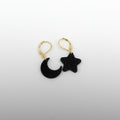 Black moon and star earrings on a white background