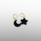 Black moon and star earrings on a white background