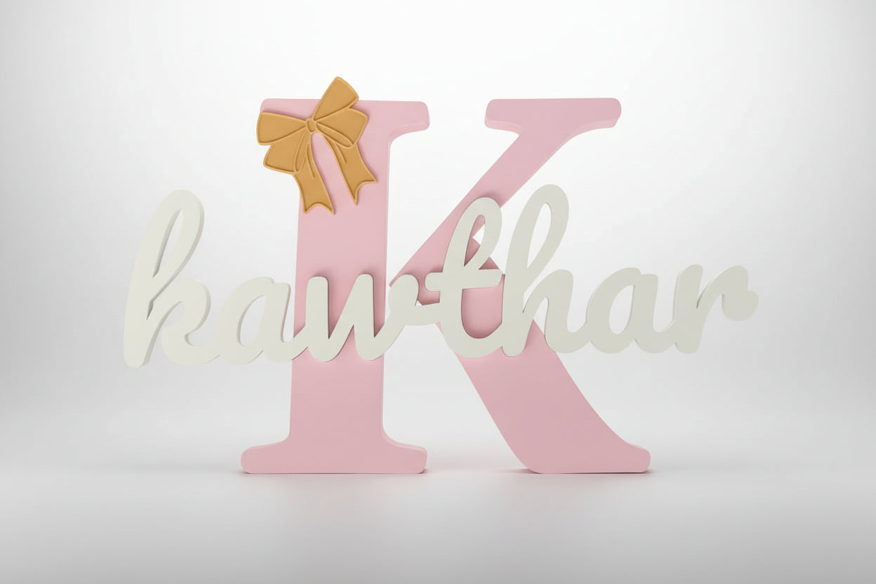 Decorative letter 'K' with a gold bow on a white background
