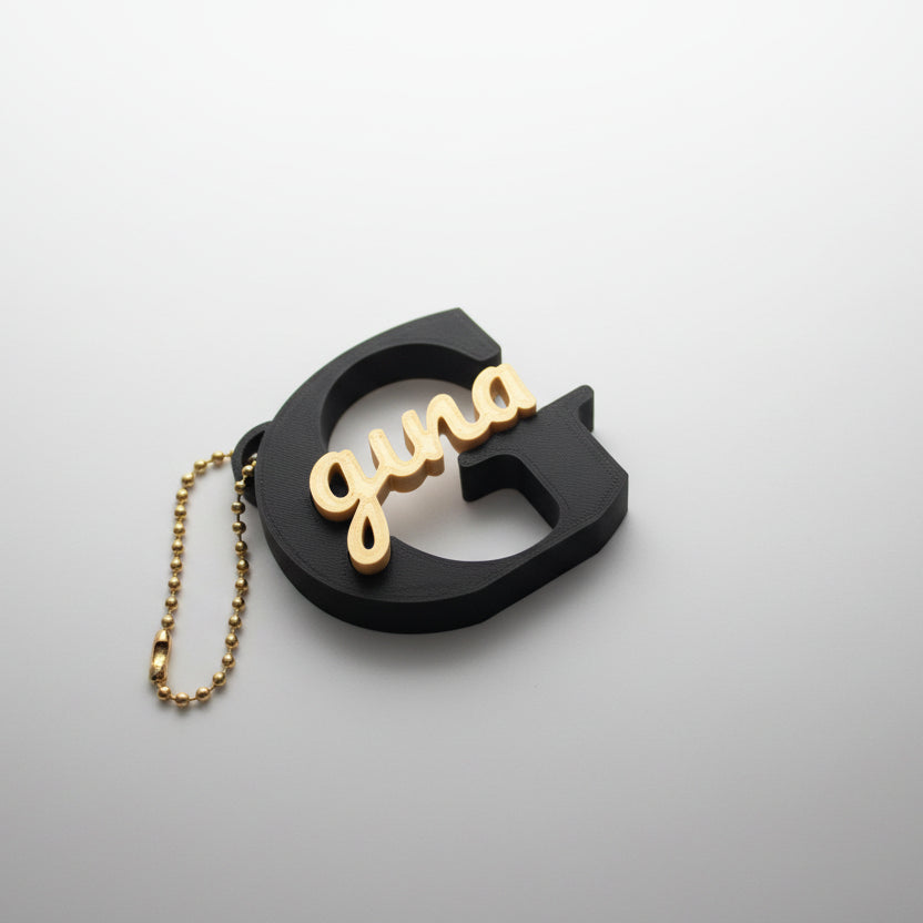 Personalized sign keychain close-up showing custom name engraving in black and gold