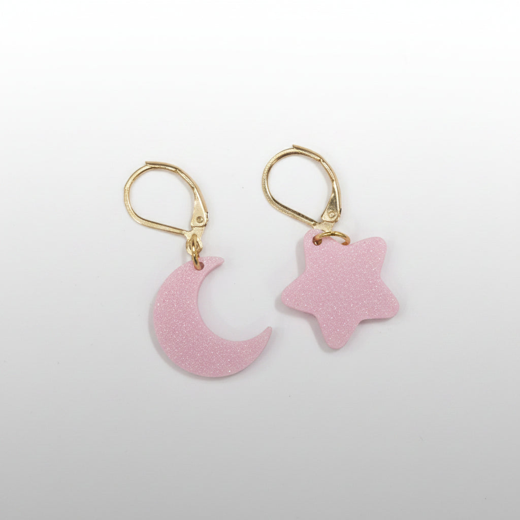 Pink moon and star earrings on a white background