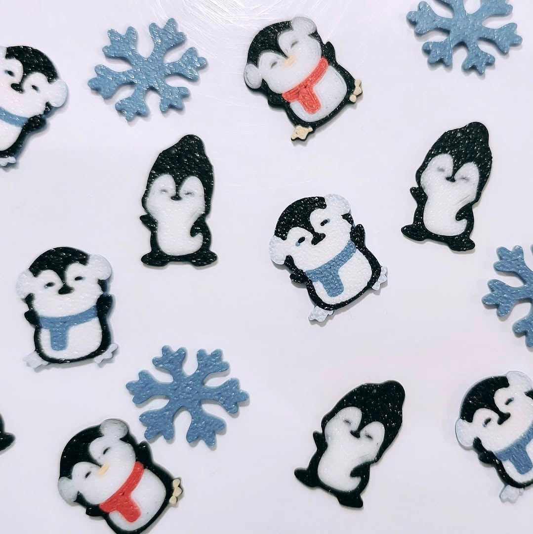 Custom 3D printed piece by Aurelis Design Studio of penguins and snowflakes on a white background