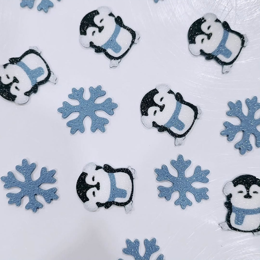 Custom 3D printed piece by Aurelis Design Studio of penguins and snowflakes on a white background
