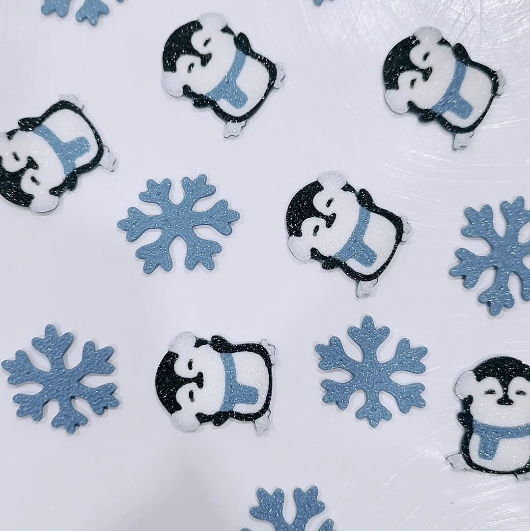Custom 3D printed piece by Aurelis Design Studio of penguins and snowflakes on a white background
