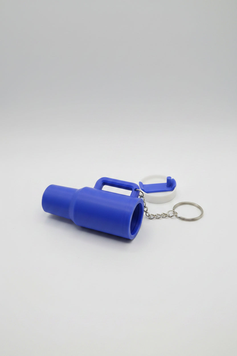 Blue container with handle and keychain on a white background