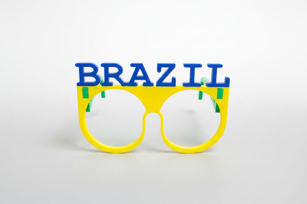 Colorful sunglasses with 'BRAZIL' text on a textured gray background