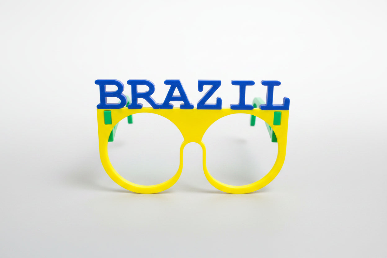 Colorful sunglasses with 'BRAZIL' text on a textured gray background