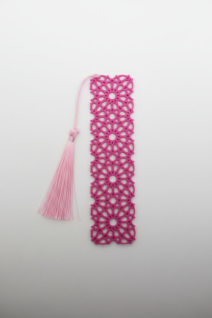 3D printed Pink lace bookmark with a tassel on a light gray background