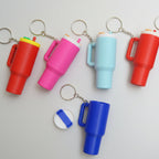 Colorful keychains shaped like stanley cups on a white background