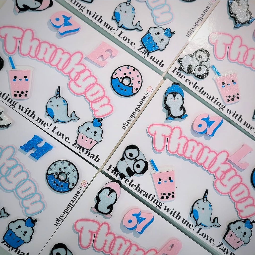 sheets with pins of cute characters and 'Thankyou' text, arranged in a gridby Aurelis Design Studio